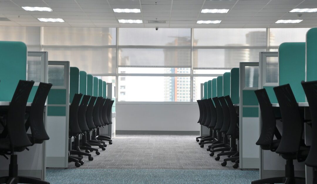 Rangées de bureaux et de chaises vides dans un plateau de bureaux désert